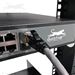 Shown Inserted Into Network Switch with Ethernet Patch Cable Attached